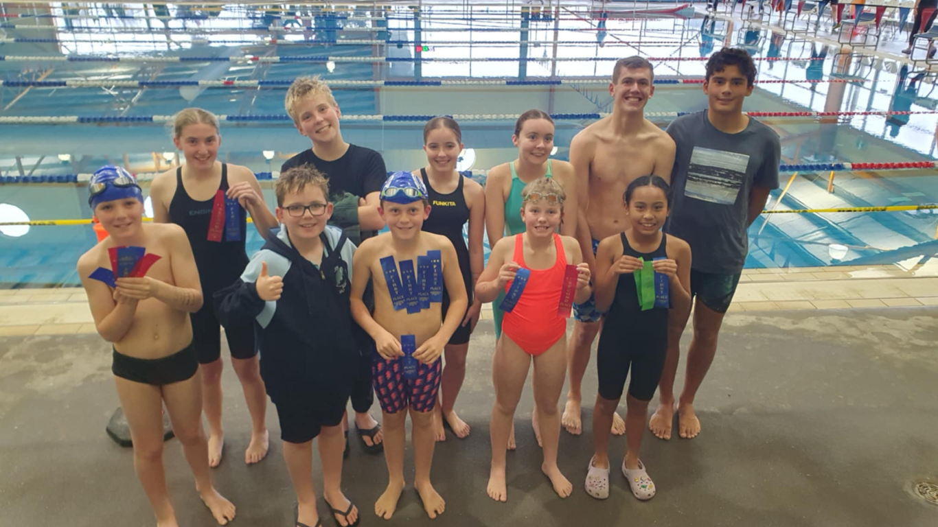 Portland Swimming Club standing next to the Hamilton Indoor Pool